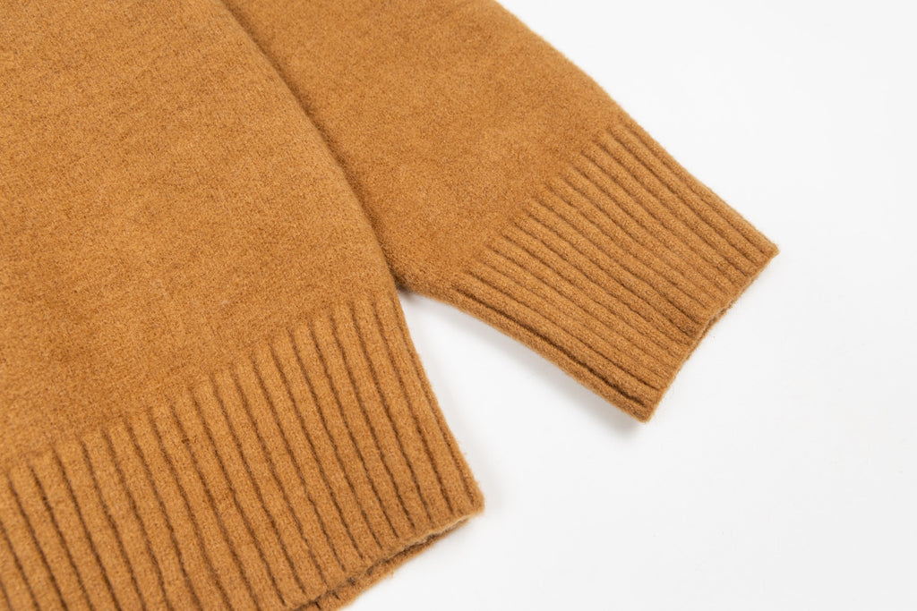 Tan cardigan sleeves with ribbed cuffs and knit hem