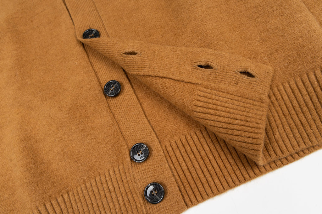 Amiri button-front knit sweater with ribbed cuffs and tan buttons