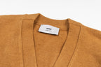 Amiri label on tan knit cardigan neckline with V-neck ribbed trim