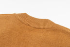 Ribbed knit collar and shoulder detail on tan cardigan sweater