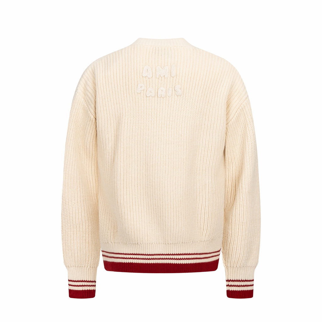 Cream knit sweater back view with red-and-white striped ribbed hem and cuffs