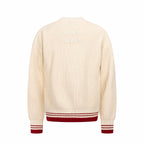 Cream knit sweater back view with red-and-white striped ribbed hem and cuffs