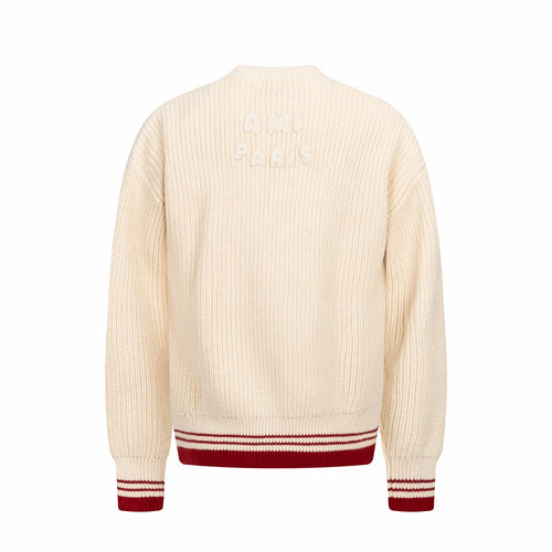Cream knit sweater back view with red-and-white striped ribbed hem and cuffs