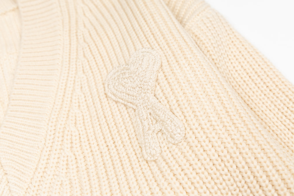 Cream knit sweater chest with raised embroidered floral script