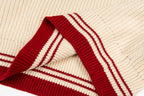 Cream knit sleeve cuff with red-and-white striped ribbing