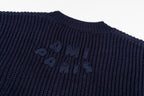 Navy knit sweater with dark embroidery logo across the chest