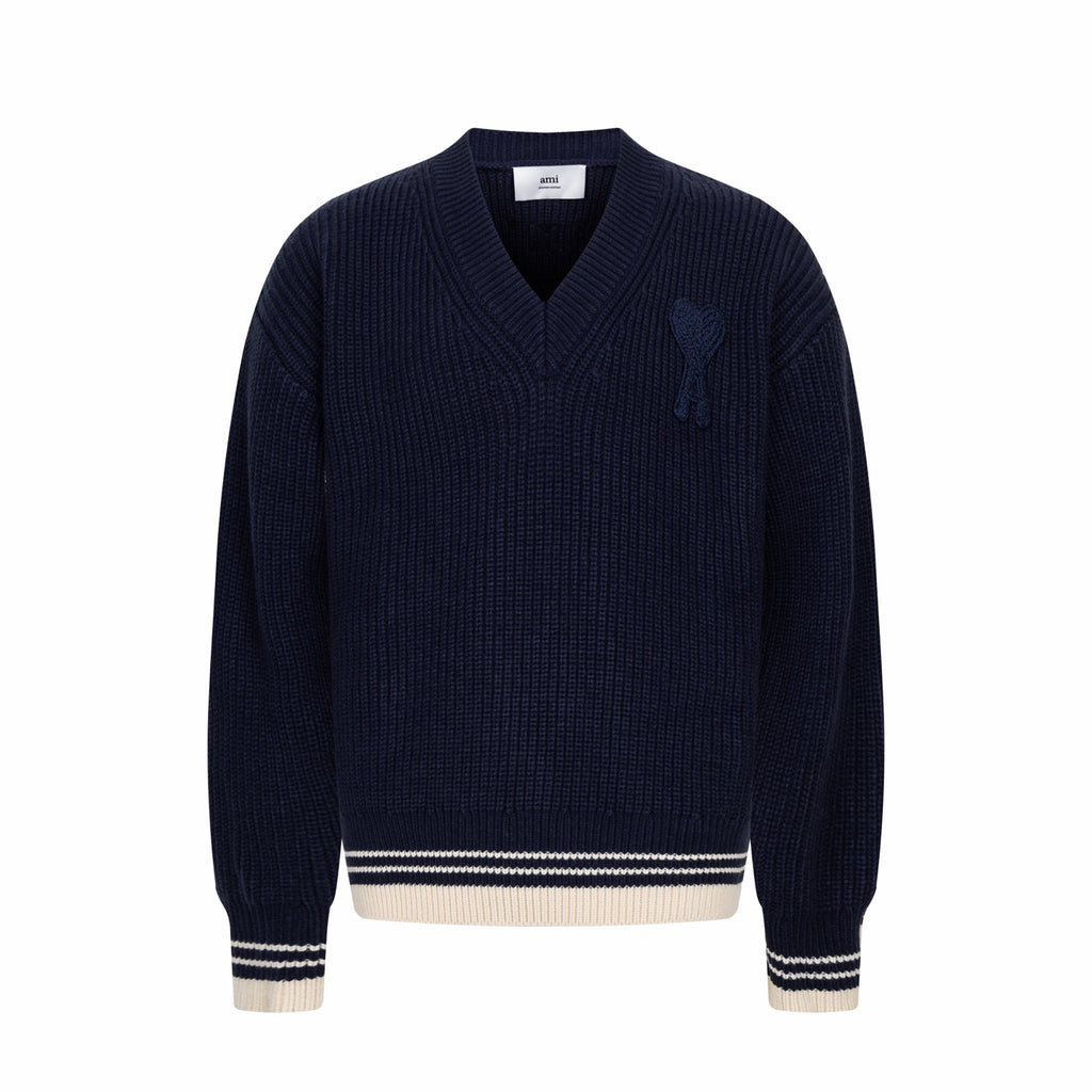 Navy knit sweater with V-neck and ribbed trim at cuffs and hem