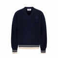 Navy knit sweater with V-neck and ribbed trim at cuffs and hem