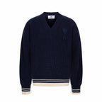 Navy knit sweater with V-neck and ribbed trim at cuffs and hem