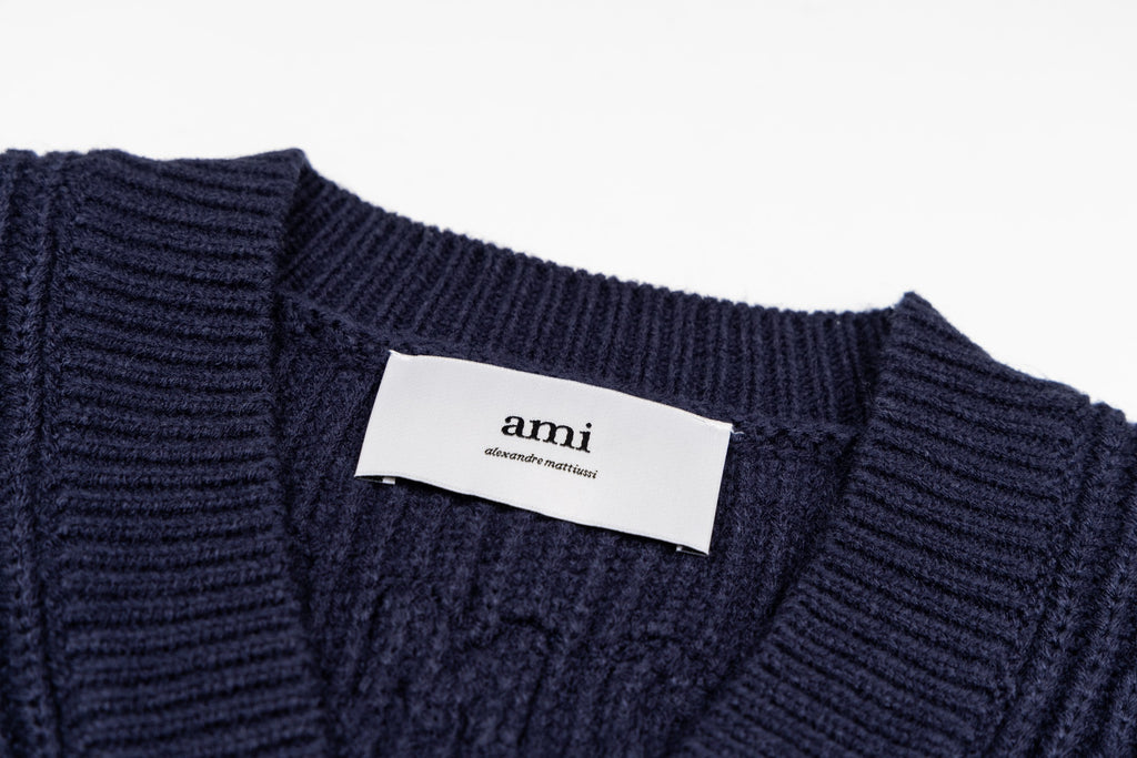 Navy knit sweater collar with ribbed neckline and brand label tag