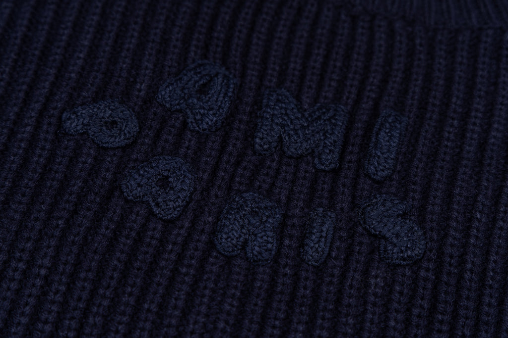 Navy ribbed knit sweater with embroidered motif on the knit panel