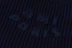 Navy ribbed knit sweater with embroidered motif on the knit panel