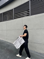 Black tapered pants with side pocket and Fendi-logo patch on the hip