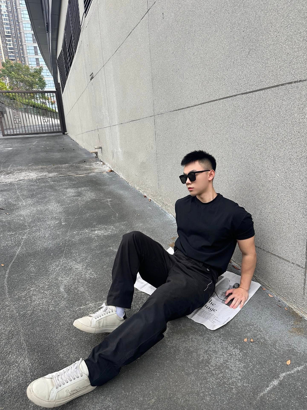 Black tapered pants in a seated pose with side pocket and cuffed hem