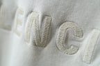 Embossed Balenciaga lettering on off-white hoodie fabric