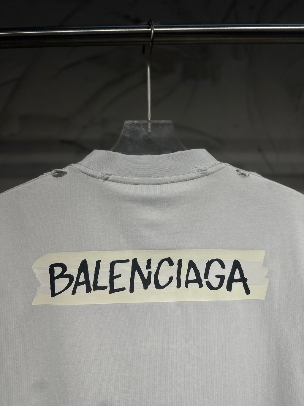 White Balenciaga T-shirt back view close-up showing large logo across upper back