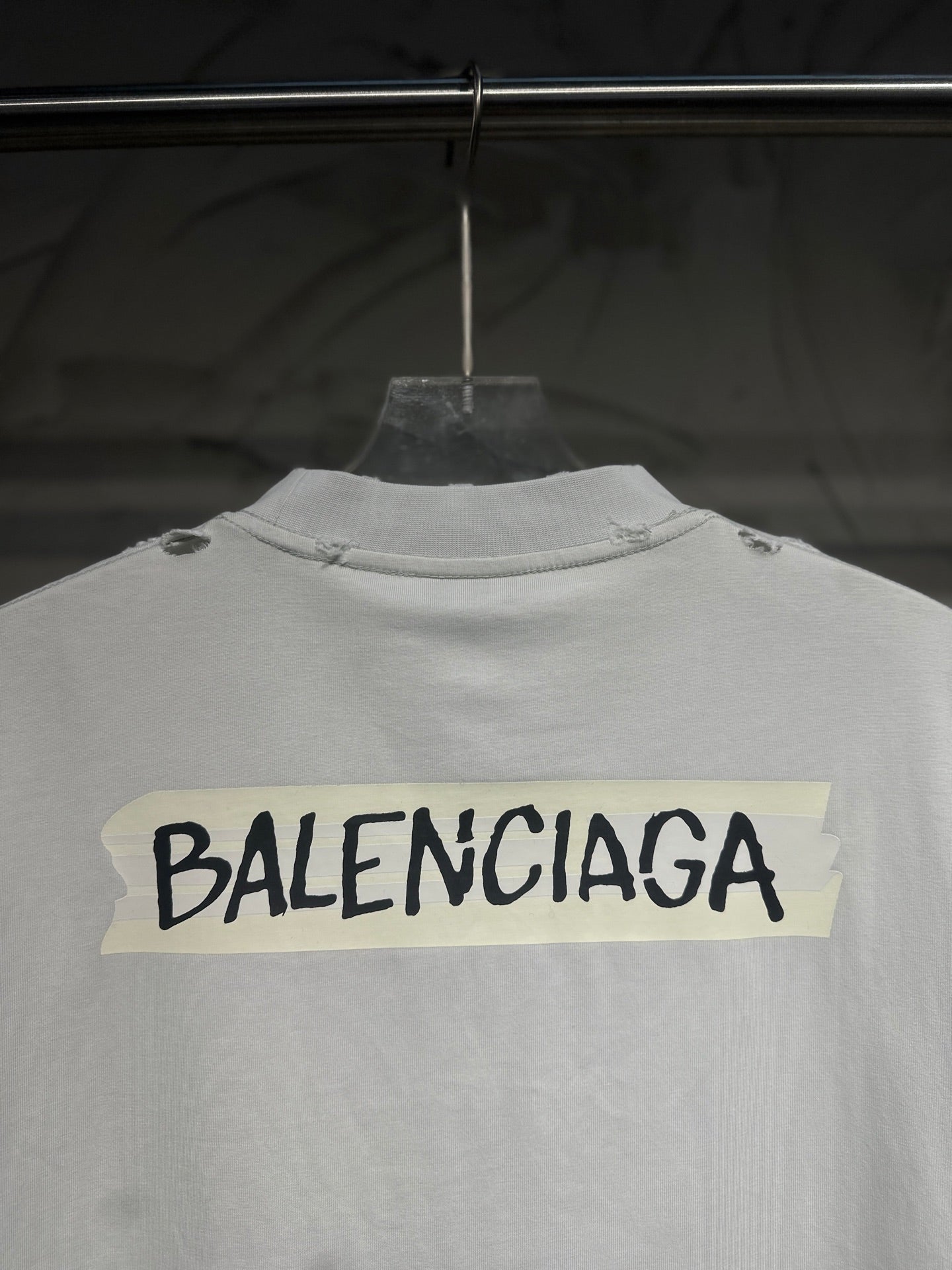 White Balenciaga T-shirt back view close-up showing large logo across upper back