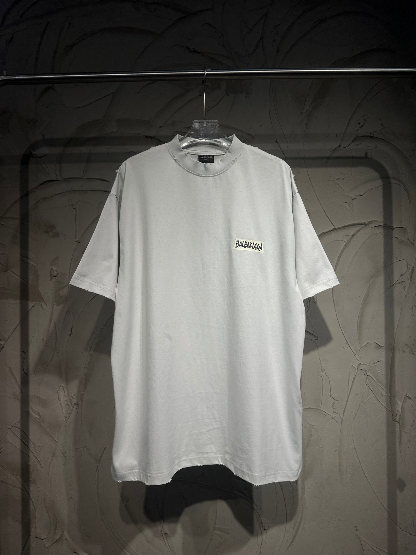 White Balenciaga short-sleeve T-shirt on hanger with small chest logo print