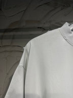 White Balenciaga T-shirt shoulder and upper sleeve in close-up