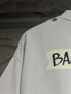 Balenciaga shorts with distressed light-gray fabric and partial black logo print