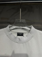 White crewneck Balenciaga T-shirt close-up showing neckline and chest logo