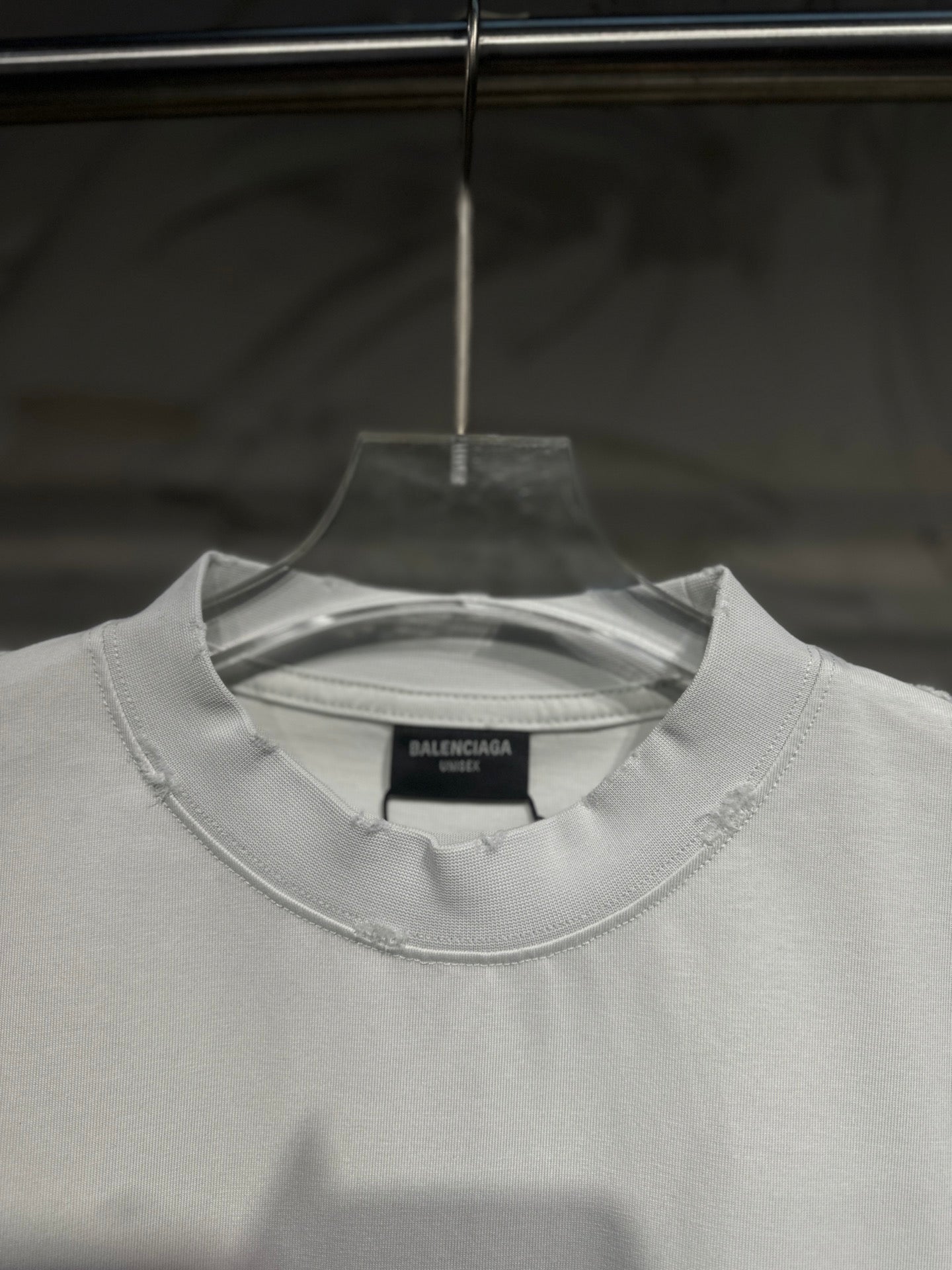 White crewneck Balenciaga T-shirt close-up showing neckline and chest logo