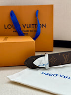 Louis Vuitton belt with dark brown monogram strap and silver buckle detail