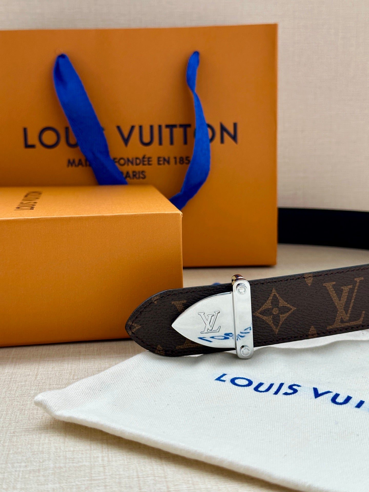 Louis Vuitton belt with dark brown monogram strap and silver buckle detail