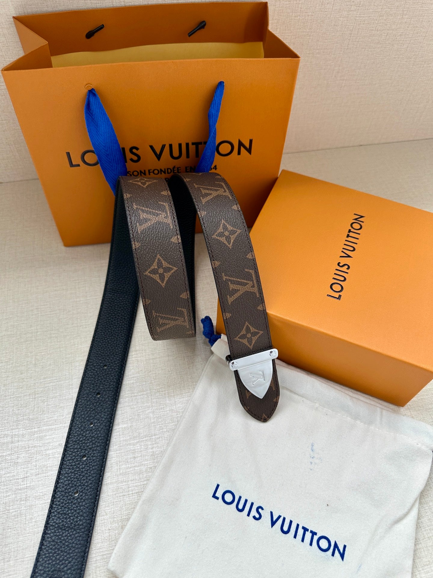 Louis Vuitton reversible-style belt with dark brown monogram strap and silver buckle