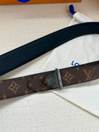 Louis Vuitton belt with dark brown monogram strap and silver buckle, close side view