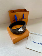 Louis Vuitton monogram belt coiled with silver buckle and dark strap