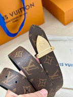Louis Vuitton belt buckle close-up on dark brown monogram strap