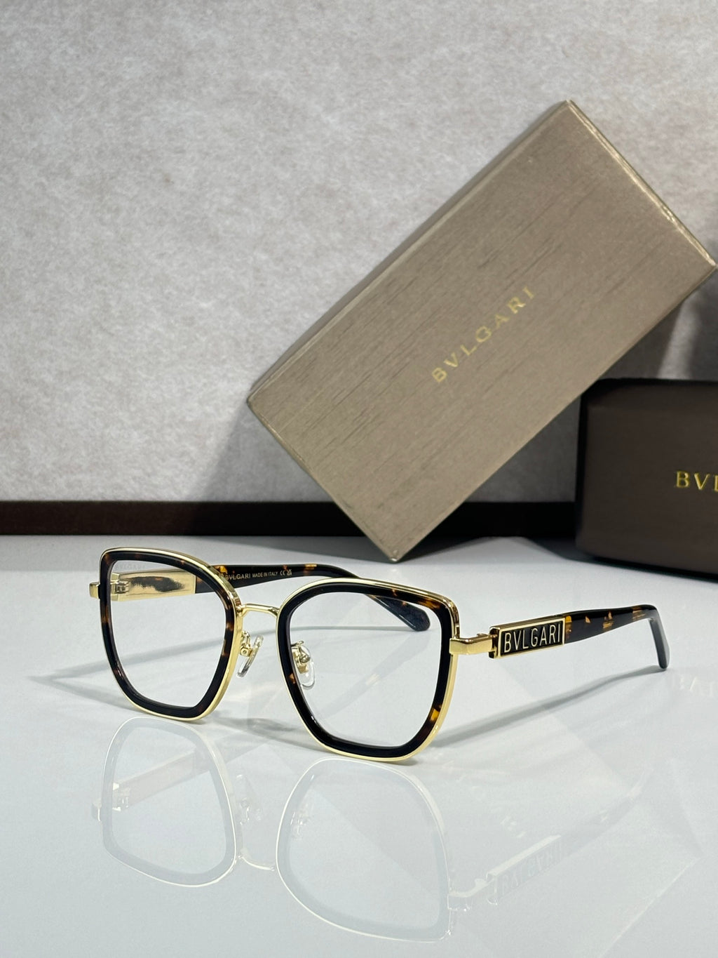 Bvlgari eyeglasses with dark frame and gold-toned temples, clear lenses, front view