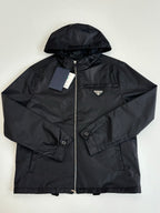 Prada black hooded jacket with full zip, chest logo patch, and drawstring hood