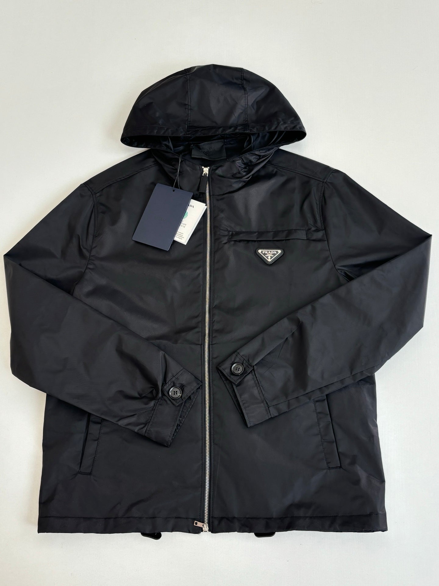 Prada black hooded jacket with full zip, chest logo patch, and drawstring hood