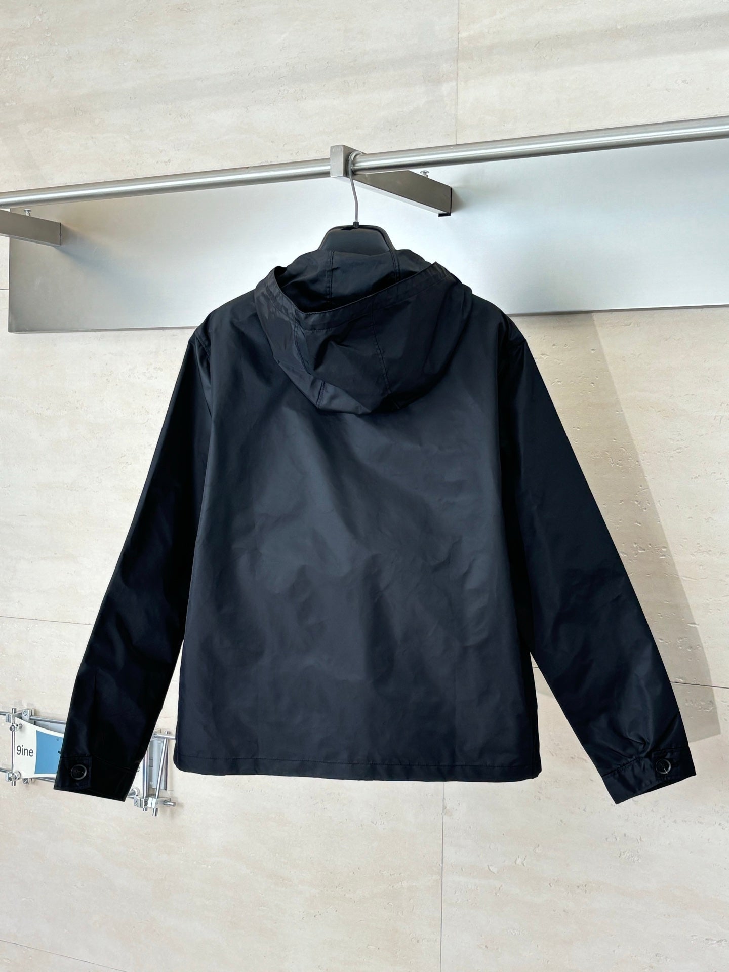 Prada black hooded long jacket, back view with full zip and logo