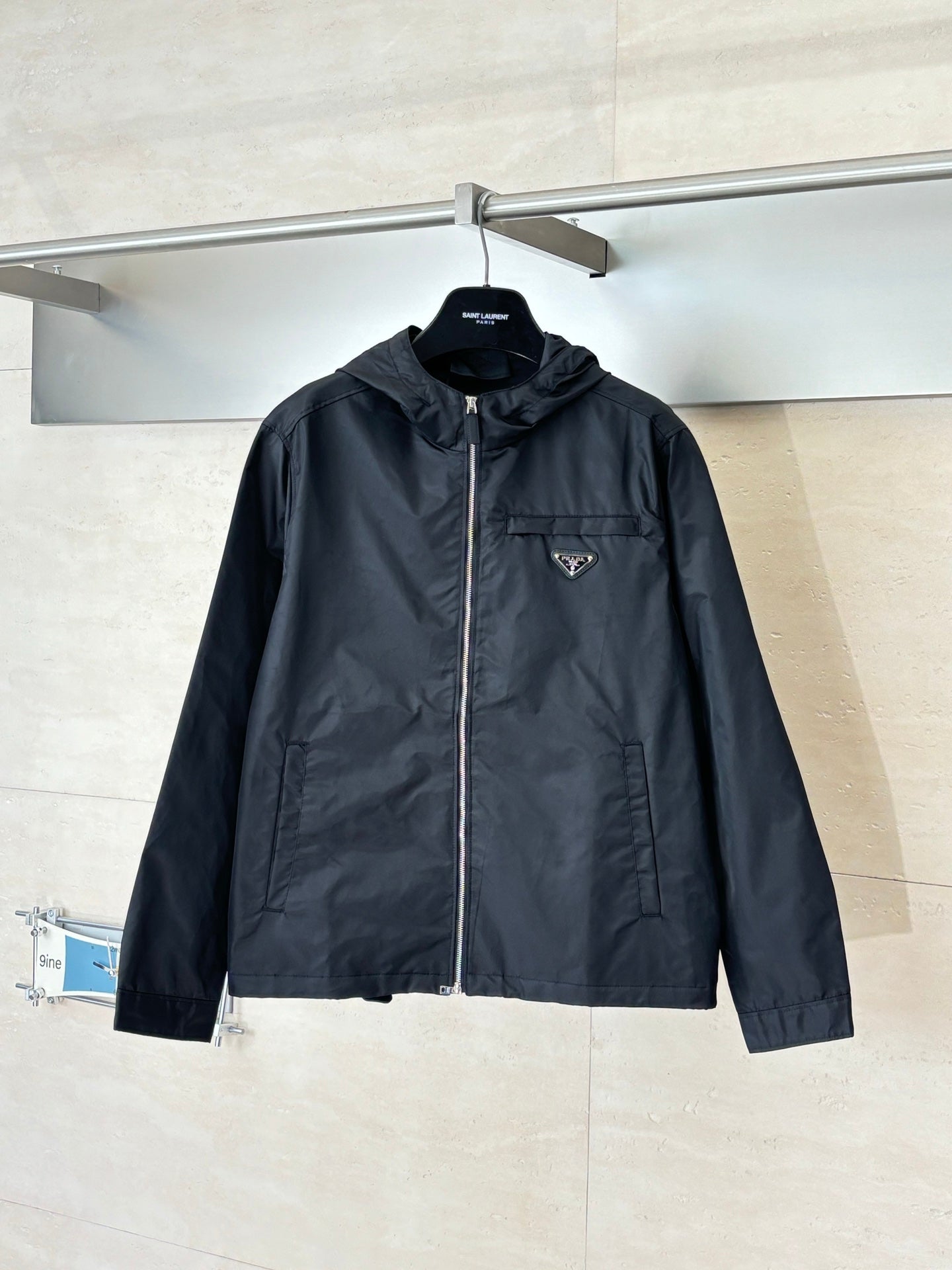 Prada long hooded jacket in black with full zip and chest logo patch