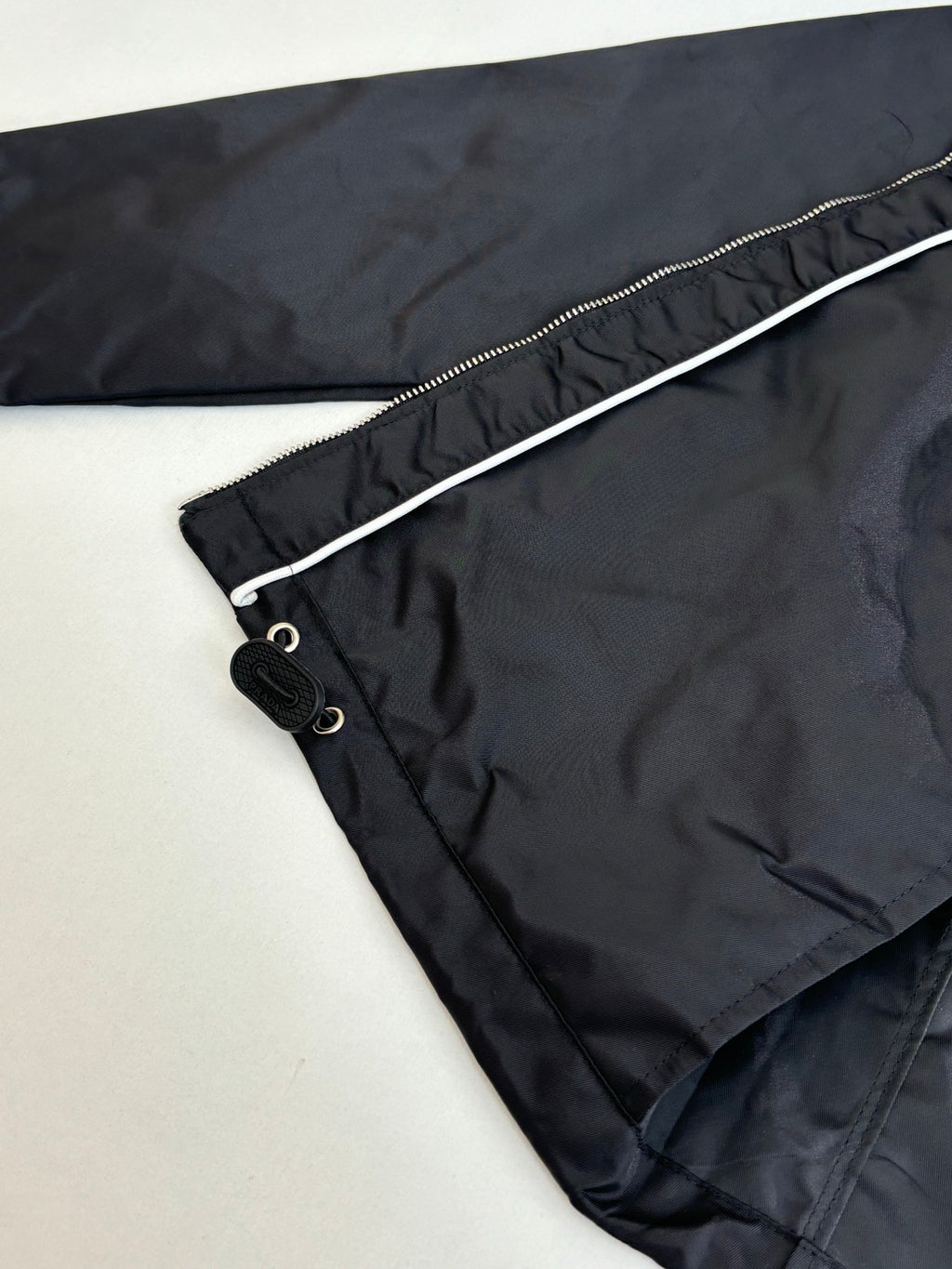 Prada black jacket interior hem detail with drawstring and buttoned pocket