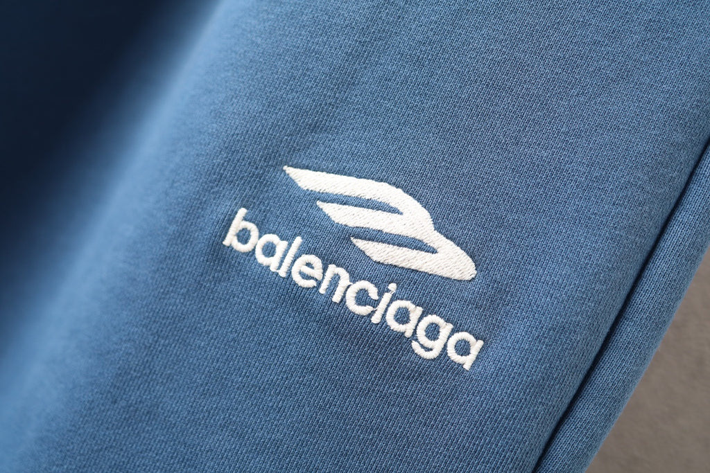Balenciaga logo patch on blue fabric pant leg