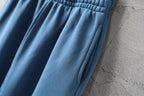 Blue pants with gathered elastic waist and draped front pleats