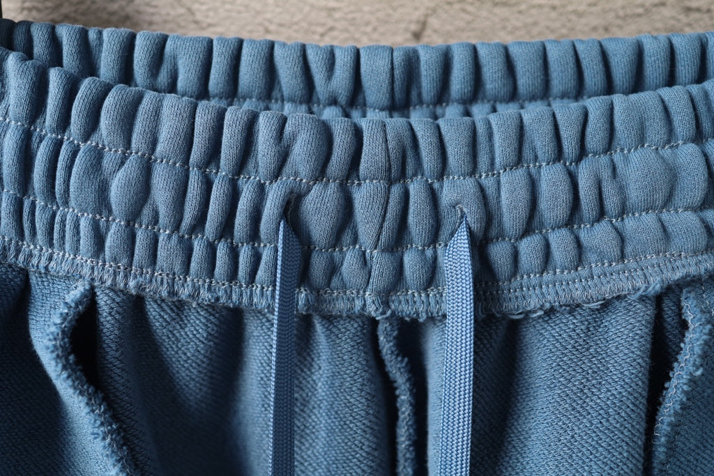 Blue elastic waistband with gathered fabric and vertical seam details