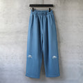 Balenciaga wide-leg pants in light blue with elastic waistband and cuffed hem