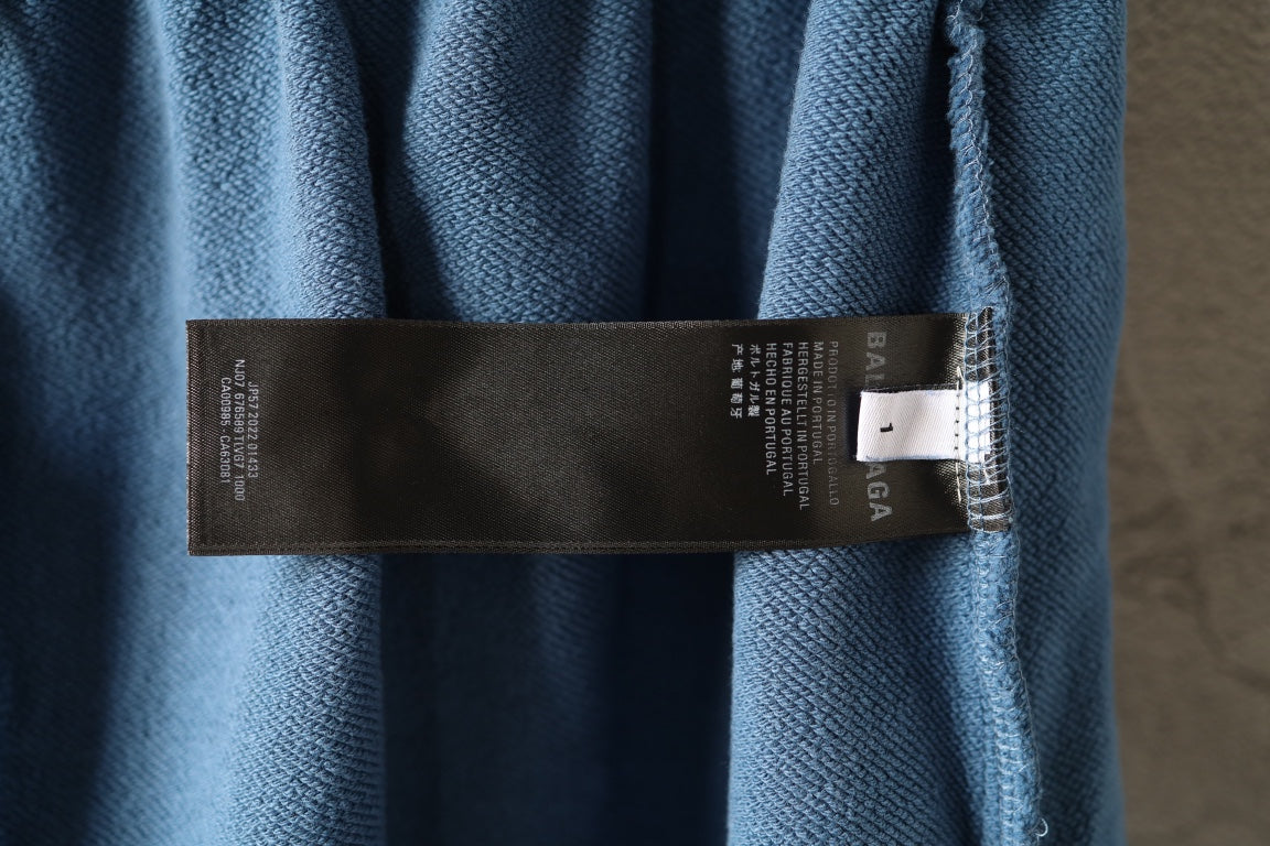 Light blue pants with black care label on fabric near hem