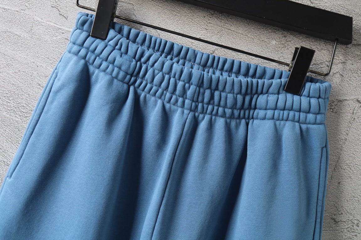 Blue pants with smocked elastic waistband and front pleats
