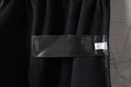Balenciaga black pants with care label and size tag on waistband