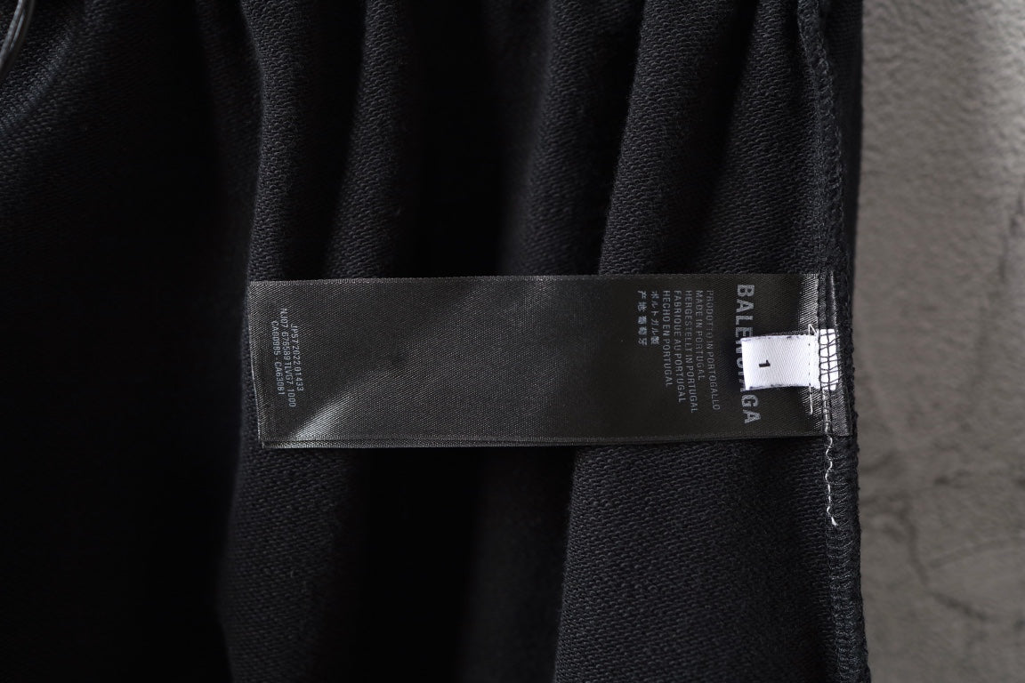 Balenciaga black pants with care label and size tag on waistband