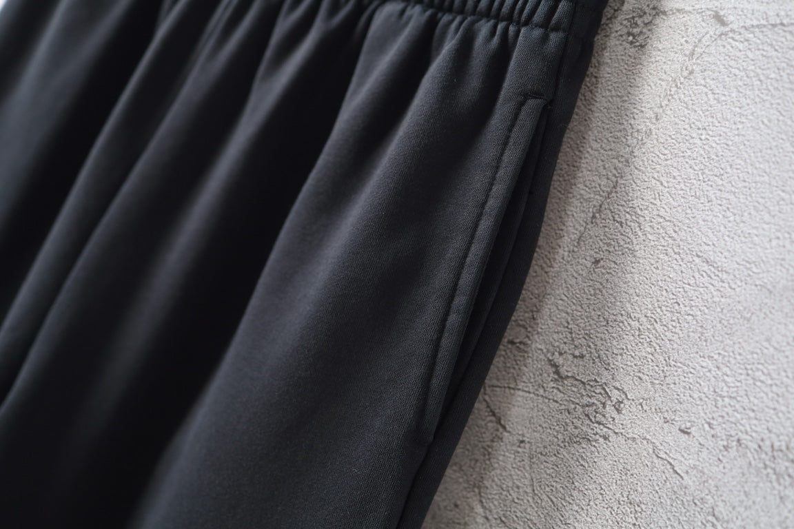 Balenciaga black wide-leg pants with smooth, flowing fabric