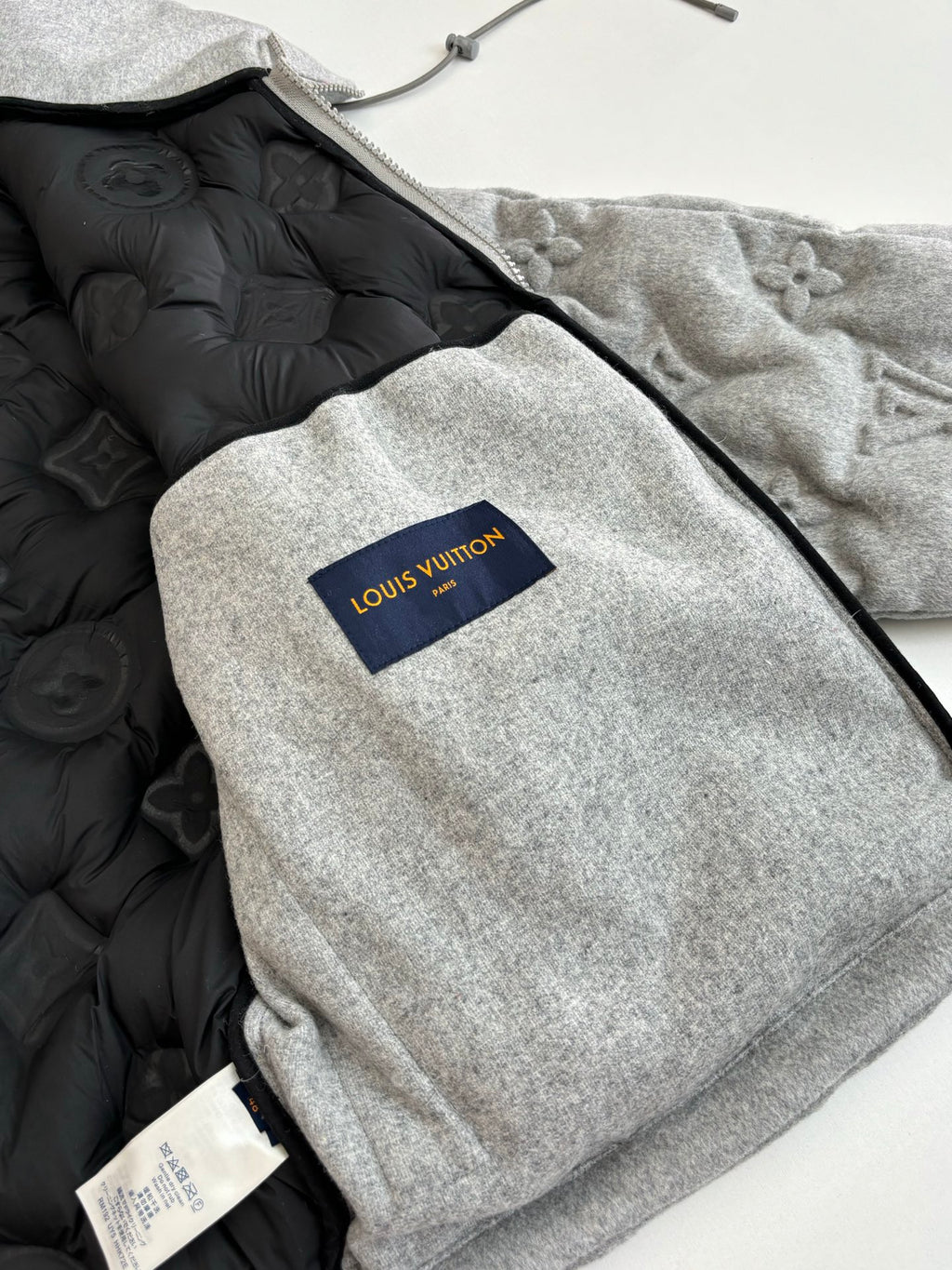 Grey long coat with black puffer lining and Louis Vuitton logo patch