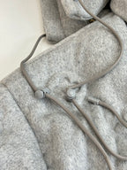 Light gray Louis Vuitton monogram jacket with adjustable hood cords and drawstring