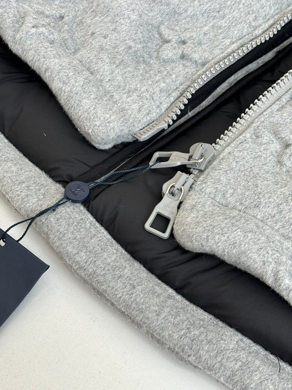 Light gray Louis Vuitton monogram jacket with black lining and metal zipper pull